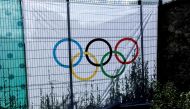This photograph shows a banner with a sign of Olympic rings on a fence at the Chateau de Versailles, an Olympic venue for the Equestrian and modern Pentathlon, in Versailles, on July 17, 2024, ahead of the Paris 2024 Olympic Games. (Photo by STEPHANE DE SAKUTIN / AFP)