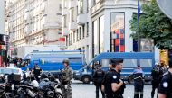 Police officers, French gendarmes and a soldier secure the aera in front of Louis Vuitton store after a man attacked a police officer with a knife, on the Champs-Elysees avenue in Paris, on July 18, 2024. (Photo by Stephane De Sakutin / AFP)