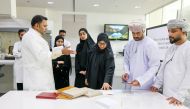 QNL officials with the Omani students during a session of the training programme.