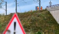 SNCF employees repair the scene of a suspected attack on the Eastern high speed railway network in Vandieres, north eastern France on July 26, 2024, as France's high-speed rail network was hit by an attack disrupting the transport system, hours before the opening ceremony of the Paris 2024 Olympic Games. Photo by Jean-Christophe VERHAEGEN / AFP