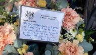 A floral tribute with a message from Britain's Prime Minister Keir Starmer is laid on Hart Street in Southport, northwest England, on July 30, 2024, a day after a deadly knife attack. (Photo by Justine Gerardy / AFP)
