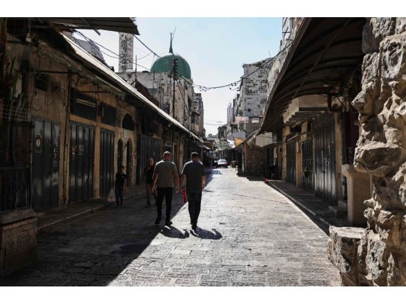 Palestinians walk through deserted commercial area in Nablus, occupied West Bank. AFP file photo.
