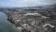 An aerial image shows Old Lahaina Center and Foodland Lahaina standing amongst destroyed homes and businesses along Front Street burned to the ground in the historic Lahaina in the aftermath of wildfires in western Maui in Lahaina, Hawaii on August 10, 2023. Photo by Patrick T. Fallon / AFP