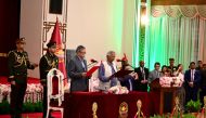 Nobel Peace Prize winner Muhammad Yunus (centre) takes the oath of office to lead Bangladesh's interim government as its chief adviser, days after a student-led uprising ended the 15-year rule of Sheikh Hasina, in Dhaka on August 8, 2024. (Photo by Munir Uz Zaman / AFP)