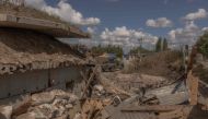 Ukrainian servicemen drive a Humvee military vehicle past a destroyed border crossing point with Russia, in the Sumy region, on August 14, 2024. (Photo by Roman PILIPEY / AFP)
