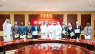 QIIB Chief Executive Officer Dr Abdulbasit Ahmed al Shaibei along with other officials honoring outstanding employees.