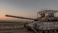 Ukrainian servicemen operate a tank on a road near the border with Russia, in the Sumy region of Ukraine, on August 14, 2024. (Photo by Roman Pilipey / AFP)

