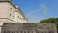 Firefighters direct water onto the roof of Somerset House after smoke from a fire was seen coming from the roof earlier in the afternoon, beside the River Thames in London on August 17, 2024. (Photo by James RYBACKI / AFP)
