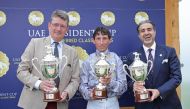 The connections of Al Shaqab Racing's Luwsail pose with their trophies after winning the UAE President Cup. 