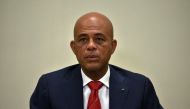 (FILES) Haitian President Michel Martelly awaits the ceremonial signing of an agreement to install a transitional government on February 6, 2016 in Port-au-Prince, Haiti. (Photo by HECTOR RETAMAL / AFP)
