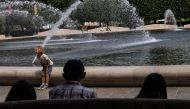A child sits near a fountain at the National Gallery of Art Pavilion Cafe in Washington, DC, on August 20, 2024. (Photo by Anna Rose Layden/Getty Images/AFP)

