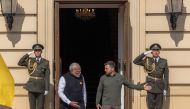 Ukrainian President Volodymyr Zelensky (R) shows the way to Indian Prime Minister Narendra Modi at the entrance of the Mariinskyi Palace during their meeting, on August 23, 2024. (Photo by Roman PILIPEY / AFP)
