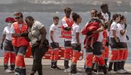 Members of the emergency services help a woman and a little child, part of a group of 136 African migrant people, upon their arrival at La Restinga port aboard the Spanish Salvamento Maritimo (Sea Search and Rescue agency) vessel 