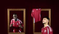 Qatar's Almoez Ali (left) and Bassam Al Rawi pose for photos sporting new national team's kit unveiled by the Qatar Football Association yesterday ahead of the third round of FIFA World Cup 2026 Qualifiers.    