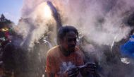 People throw powder as they take part in the annual street party J'ouvert on September 2, 2024 in New York City. (Photo by Adam Gray / GETTY IMAGES NORTH AMERICA / Getty Images via AFP)

