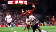 Liverpool's Japanese midfielder #03 Wataru Endo vies for the ball with Brentford's Nigerian midfielder #15 Frank Onyeka during the English Premier League football match between Liverpool and Brentford at Anfield in Liverpool, north west England on August 25, 2024. (Photo by Darren Staples / AFP)
