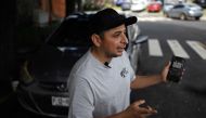 Taxi driver Napoleon Osorio shows an app on his phone that he uses to charge his rides in bitcoins in San Salvador on September 4, 2024. (Photo by Marvin Recinos / AFP)