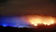Flames and embers are seen on the Koenigsberg below the Brocken, the highest point of the Harz Mountains, in Wernigerode, Saxony-Anhalt, on September 6, 2024. (Photo by Matthias Bein / dpa / AFP) 
 