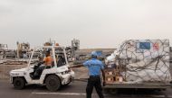 This handout photograph taken and released by the European Union's Press Service on September 5, 2024, shows a policeman gesturing during the reception of a batch of MPOX vaccines donated by European Union at the tarmac of the Kinshasa International Airport in the Nsele district of Kinshasa. Photo by EUROPEAN UNION / AFP.