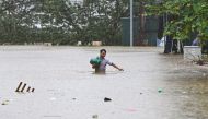 A man walks through flood waters in Hanoi on September 11, 2024, in the aftermath of Typhoon Yagi hitting northern Vietnam. (Photo by NHAC NGUYEN / AFP)
 