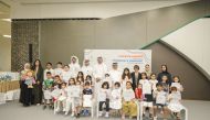 Officials and children during a visit to a metro station.