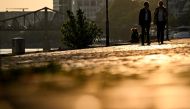 Pedestrians walk on the river Main embankment during sunset in Frankfurt am Main, western Germany, on September 18, 2024.
(Photo by Kirill KUDRYAVTSEV / AFP)
