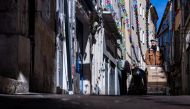 A deliveryman walks down a street in Manosque, southern France, on September 29, 2024. (Photo by JOEL SAGET / AFP)

