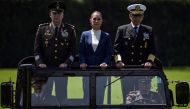 Mexico's President Claudia Sheinbaum (C), flanked by Defense Minister Ricardo Trevilla (L) and Secretary of the Navy Raymundo Pedro Morales (R), reviews troops during her inauguration ceremony as the new Supreme Commander of the Mexican Armed Forces at Campo Marte in Mexico City on October 3, 2024. (Photo by Yuri CORTEZ / AFP)
