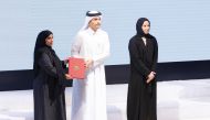 Prime Minister and Minister of Foreign Affairs H E Sheikh Mohammed bin Abdulrahman bin Jassim Al Thani honouring a teacher as Minister of Education and Higher Education H E Buthaina bint Ali Al Jabr Al Nuaimi looks on.