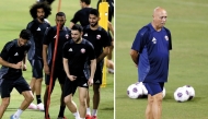 Qatar players attend a training session, yesterday (left) and Qatar coach Marquez Lopez during a training session on the eve of the match against Kyrgyzstan.