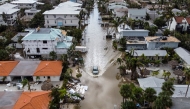 In this aerial photo, a vehicle drives though a flooded street after Hurricane Milton, in Siesta Key, Florida, on October 10, 2024. Photo by CHANDAN KHANNA / AFP.
