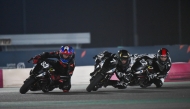 Marton Belleli (left) leads the pack during the final round of the 2024 FIM MiniGP Qatar Championship.