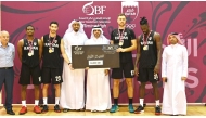 Qatar Basketball Federation President Mohammed bin Saad Al Mughaiseeb with the officials and victorious Al Rayyan players.