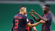 Al Duhail's Michael Olunga (right) is congratulated by teammates. 