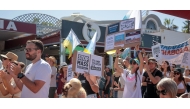 Protesters march during demonstration against mass tourism as tourists sit in a terrace, in Arona on the Spanish Canary island of Tenerife, on October 20, 2024. Photo by DESIREE MARTIN / AFP.