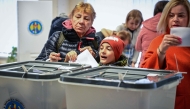 Voters cast their ballots for the presidential election and referendum on joining the European Union at a polling station in Chisinau on October 20, 2024. (Photo by Daniel Mihailescu / AFP)