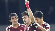 Qatar's Zaid Faisal (centre) celebrates with teammates after scoring a goal against Mongolia, yesterday.