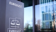 This general view shows the logo of EU Agency for Criminal Justice Cooperation (Eurojust) at the entrance to Eurojust headquarters in The Hague on February 8, 2023. Photo by Kenzo TRIBOUILLARD / AFP