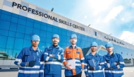 A group of UDST students pose for photo in front of the university's Professional Skills Center.