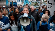 British environmentalist Chris Packham (C) joins protesters at a 