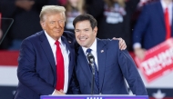 (FILES) Former US President and Republican presidential candidate Donald Trump greets Senator Marco Rubio, Republican of Florida, during a campaign rally at the J.S. Dorton Arena in Raleigh, North Carolina, on November 4, 2024. (Photo by Ryan M. Kelly / AFP)
