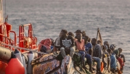 (FILES) A 'cayuco' boat from Senegal with 136 migrants onboard including 40 women and 17 young children arrives after being rescued at sea by a Spanish Salvamento Maritimo (Sea Search and Rescue agency) vessel, at La Restinga port on the Canary island of El Hierro, on November 28, 2024. (Photo by Antonio SEMPERE / AFP)
