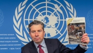 Humanitarian Affairs and Emergency Relief Coordinator (OCHA) Under-Secretary-General Tom Fletcher holds the Global Humanitarian Overwiew 2025 report during a press conference in Geneva on December 3, 2024. Photo by Elodie LE MAOU / AFP.
