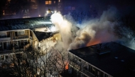Firemen try to douse a fire following a fire and an explosion at a residential building in The Hague on December 7, 2024. (Photo by Josh Walet / ANP / AFP) 