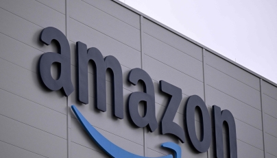 The logo of US online retail giant Amazon is seen on the facade of a redistribution centre in Horn-Bad Meinberg, western Germany, on December 9, 2024. (Photo by Ina FASSBENDER / AFP)