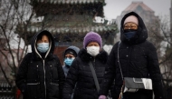 File: People wear face masks as they walk on a snowy morning as the coronavirus disease (COVID-19) continues in Beijing, China, on January 20, 2022. (Reuters)

