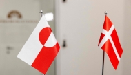 The Greenlandic (L) and Danish flags are pictured at the Ministry of Finance in Copenhagen on January 8, 2025. (Photo by Nikolai Linares / Ritzau Scanpix / AFP) / Denmark OUT
