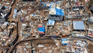 Files: This aerial view shows destroyed shelters and houses in the town of Vahibe, on the outskirts of Mamoudzou, on the French Indian Ocean territory of Mayotte, on December 24, 2024. (Photo by Patrick Meinhardt / AFP) 