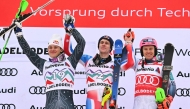 Winner France's Clement Noel (C) celebrates on the podium wih second-placed Brazil's Lucas Braathen (L) and third-placed Norway's Henrik Kristoffersen after the Men's Slalom race as part of the FIS Alpine Ski World Cup 2024-2025, in Adelboden, Switzerland on January 11, 2025. (Photo by FABRICE COFFRINI / AFP)
