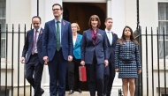 (FILES) Britain's Chancellor of the Exchequer Rachel Reeves (C), holding the red Budget Box, poses with members of her Treasury team, Parliamentary Secretary Emma Reynolds (3L), Exchequer Secretary James Murray (L), Chief Secretary to the Treasury Darren Jones (2L), Economic Secretary Tulip Siddiq (R) and Financial Secretary Spencer Livermore outside of 11 Downing Street, in central London, on October 30, 2024, to present the government's annual Autumn budget to Parliament. (Photo by JUSTIN TALLIS / AFP)
